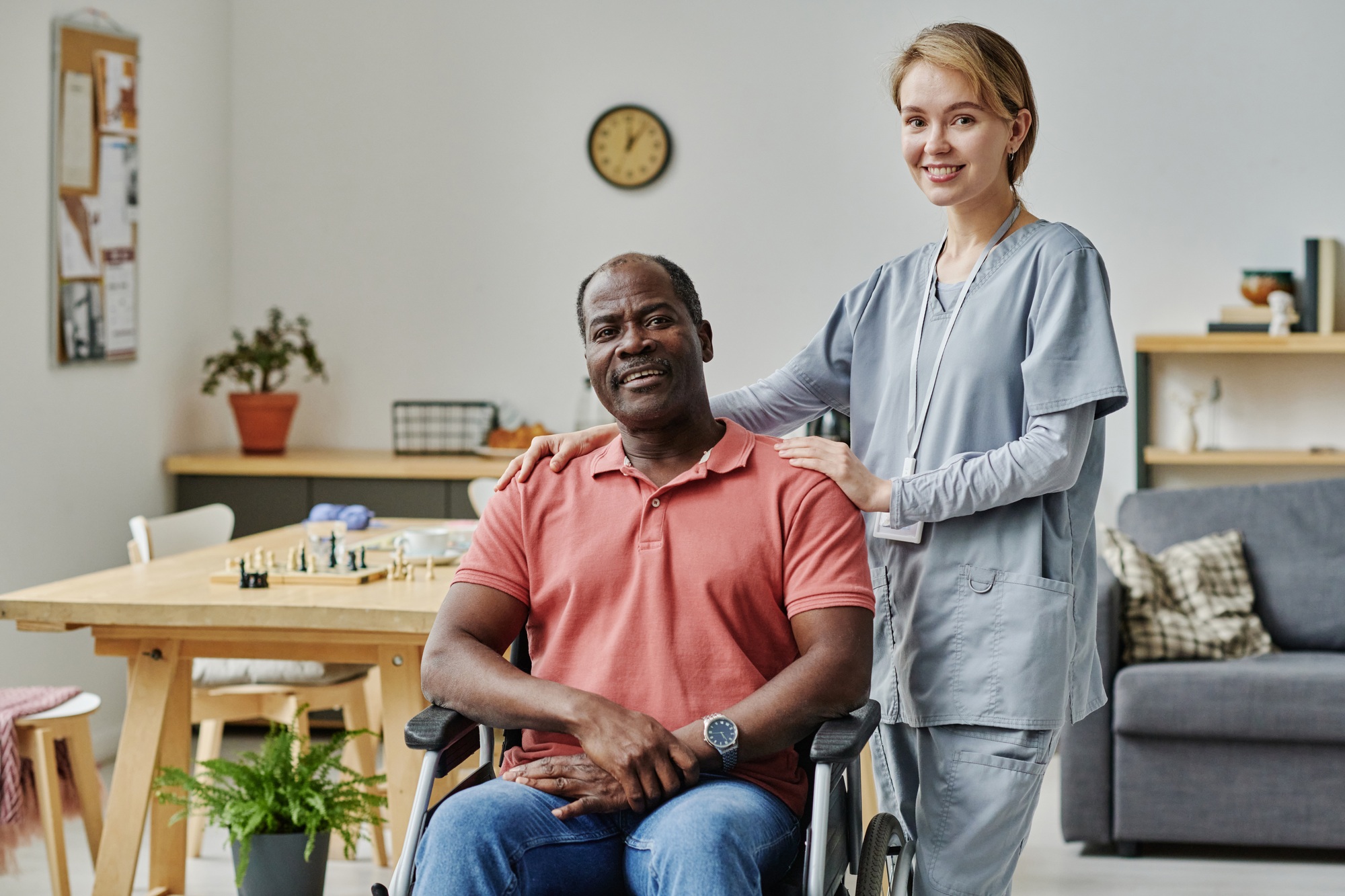 Volunteer with senior man in nursing home