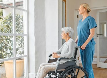 shot-of-a-nurse-caring-for-a-senior-woman-in-a-wheelchair-in-a-retirement-home.jpg